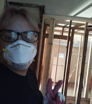 Woman wearing a face mask and glasses at a construction site