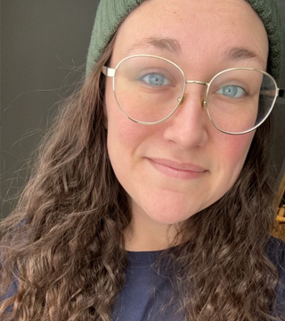 Smiling female in a hat and glasses
