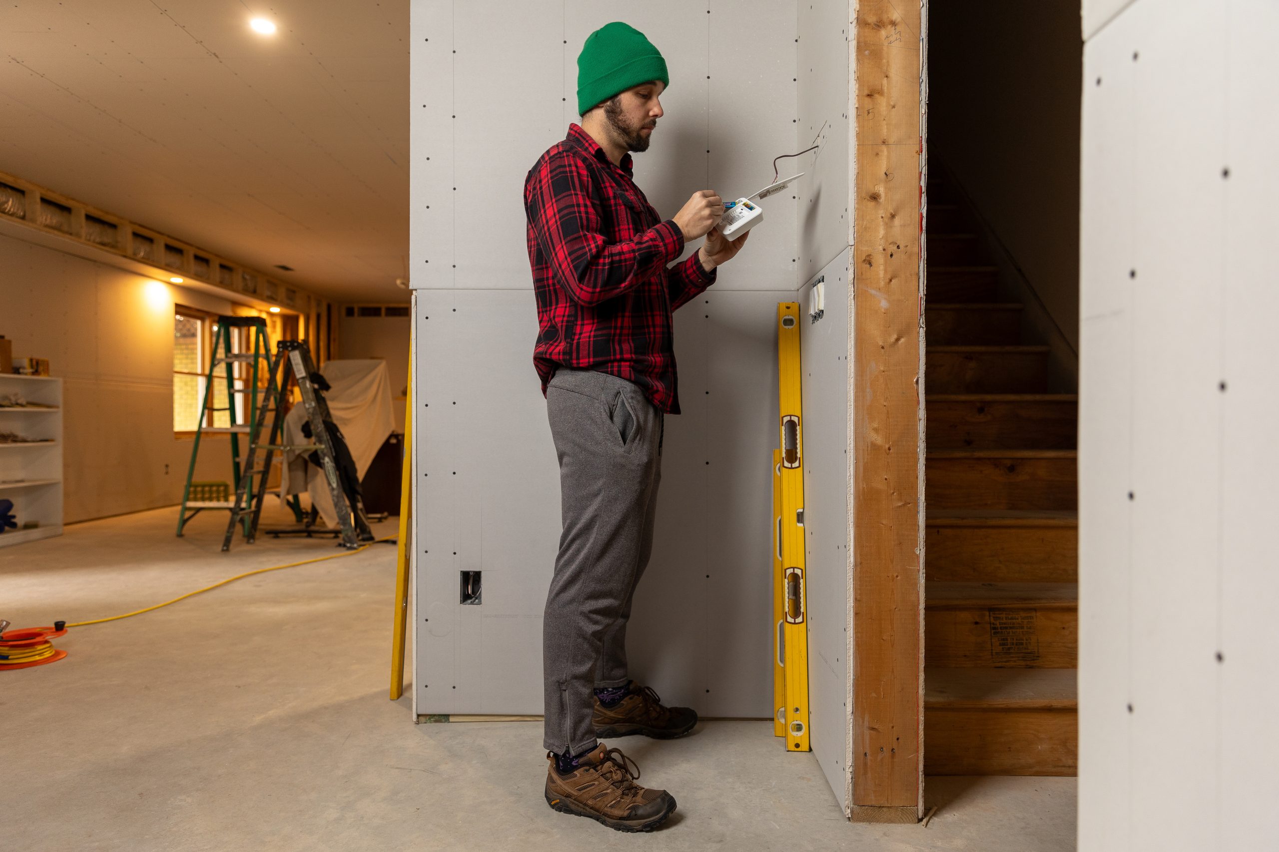 Caucasian male installing a thermostat